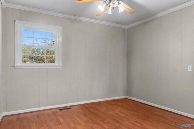 3000 Eolyne Kelly Way NE, Huntsville, AL 35811 - spare room with a ceiling fan, ornamental molding, visible vents, wood finished floors, and baseboards
