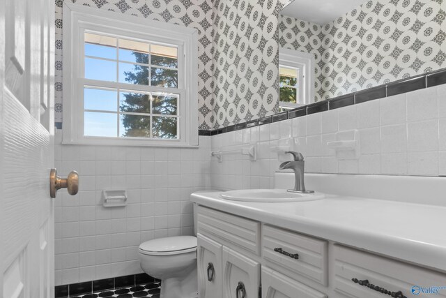 3000 Eolyne Kelly Way NE, Huntsville, AL 35811 - bathroom with vanity, wallpapered walls, toilet, wainscoting, and tile walls