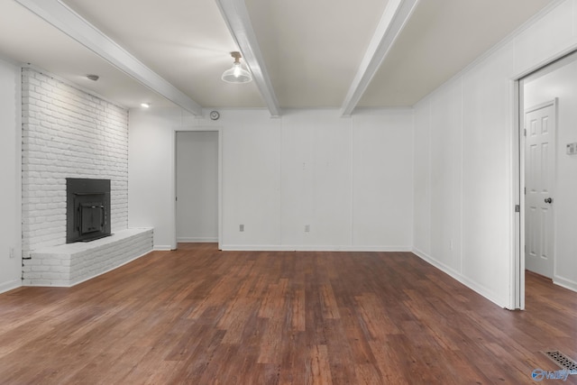 3000 Eolyne Kelly Way NE, Huntsville, AL 35811 - unfurnished living room featuring baseboards, a brick fireplace, visible vents, beam ceiling, and wood finished floors