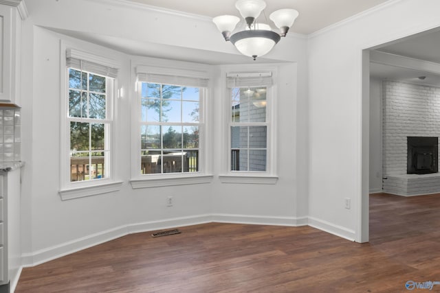 3000 Eolyne Kelly Way NE, Huntsville, AL 35811 - unfurnished dining area featuring crown molding, an inviting chandelier, visible vents, wood finished floors, and baseboards