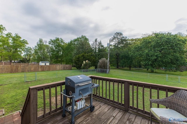 wooden deck featuring a yard and a fenced backyard