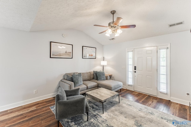 living room with wood finished floors, ceiling fan, baseboards, visible vents, and lofted ceiling