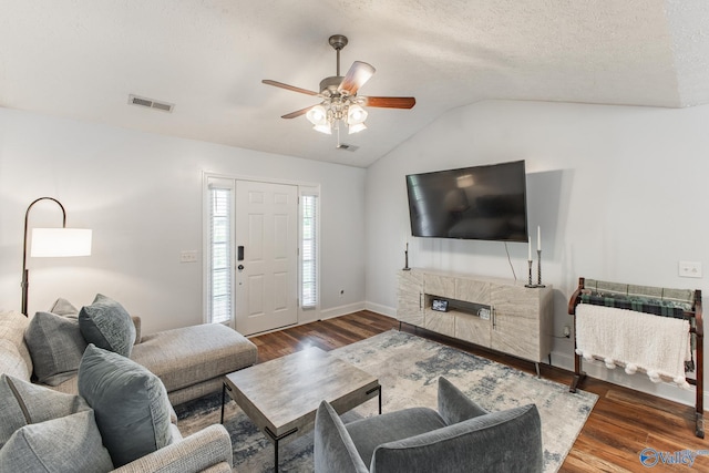 living room featuring visible vents, wood finished floors, ceiling fan, and vaulted ceiling