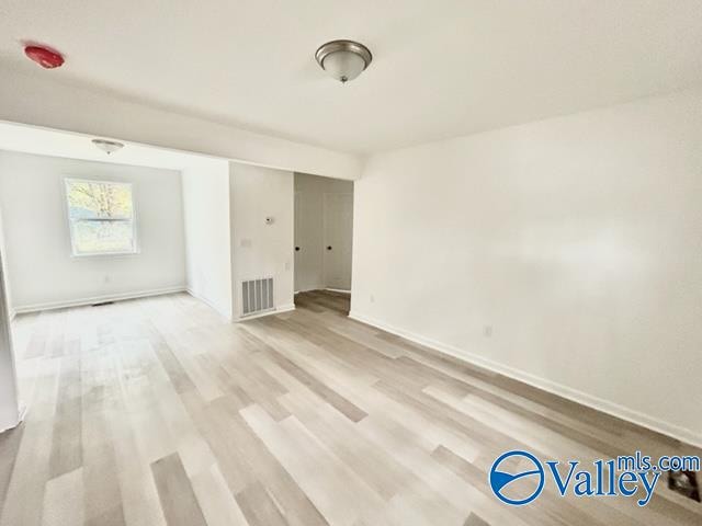 unfurnished room with light hardwood / wood-style floors