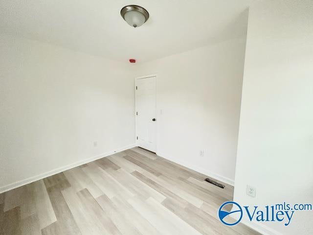 spare room with light wood-type flooring