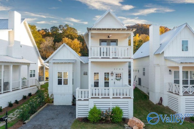 view of front of house with a balcony, covered porch, and board and batten siding