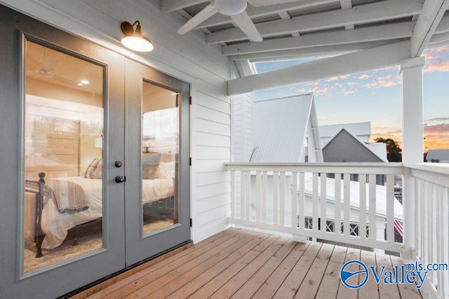 wooden terrace with french doors and a ceiling fan