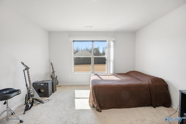 bedroom with carpet floors, visible vents, and baseboards