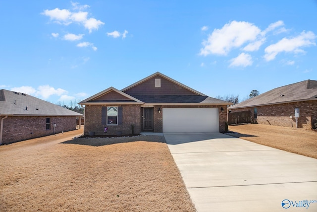 view of front of property with an attached garage, driveway, a front lawn, and brick siding