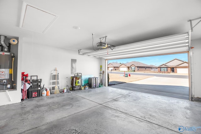 garage with electric panel, gas water heater, and a garage door opener