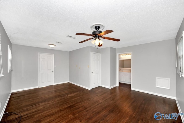 unfurnished room featuring visible vents, baseboards, a ceiling fan, and wood finished floors