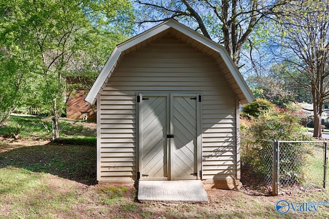 view of shed featuring fence