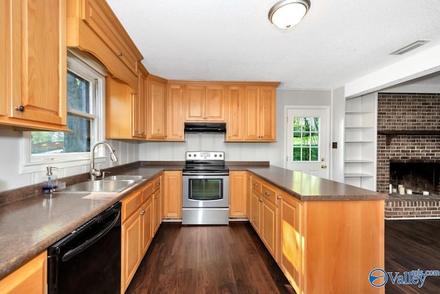 kitchen with stainless steel range with electric cooktop, black dishwasher, under cabinet range hood, a sink, and dark countertops