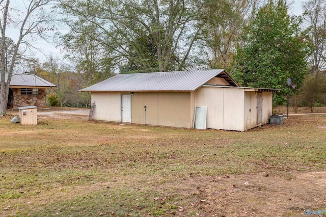 view of outbuilding featuring a lawn