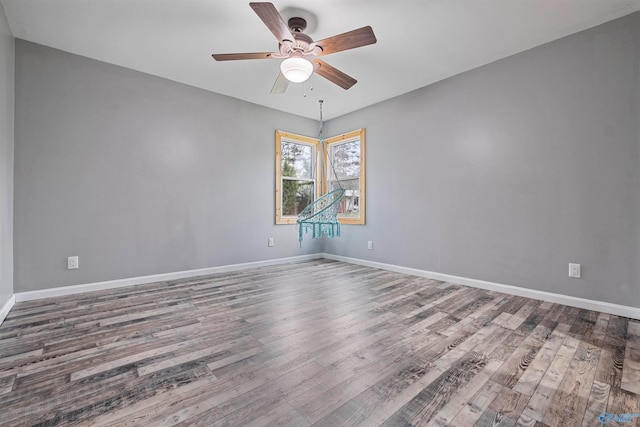 spare room with ceiling fan and wood-type flooring