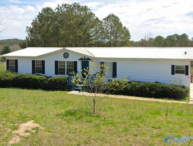 ranch-style house with metal roof and a front lawn