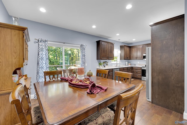 dining space with hardwood / wood-style flooring and sink