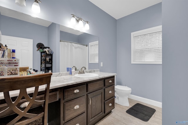 bathroom featuring curtained shower, tile patterned floors, vanity, and toilet