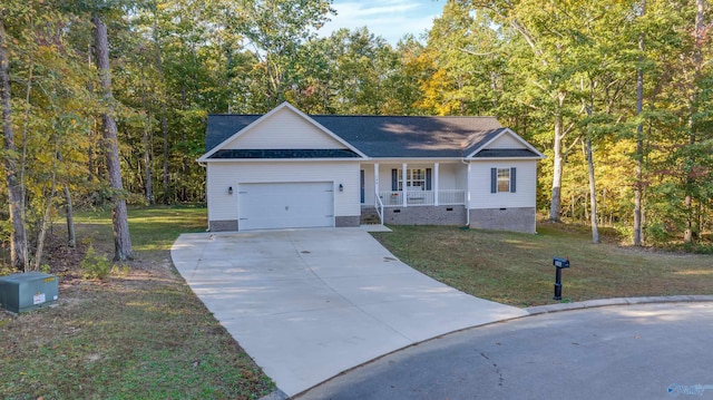 ranch-style house with a garage, covered porch, and a front yard