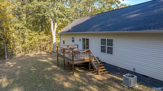 rear view of house with central AC, a yard, and a deck