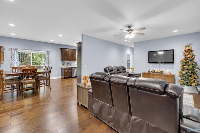 living room with dark hardwood / wood-style flooring and ceiling fan