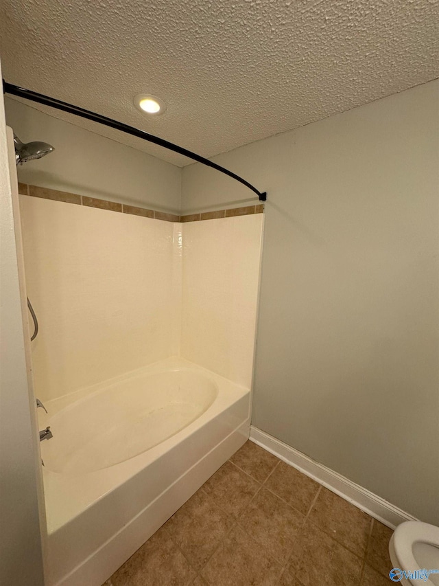 bathroom featuring shower / bathing tub combination, a textured ceiling, tile patterned flooring, and toilet