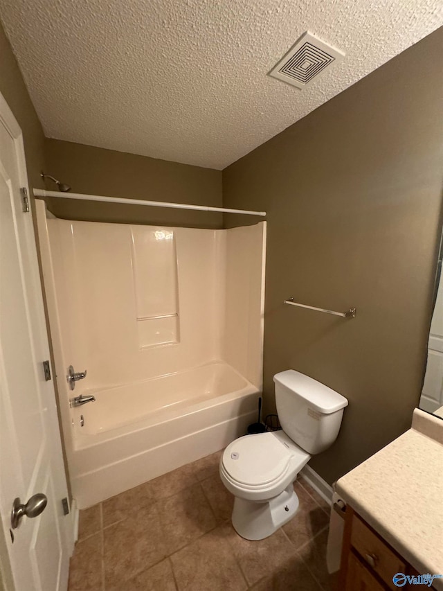 full bathroom featuring vanity, tile patterned floors, shower / bath combination, toilet, and a textured ceiling