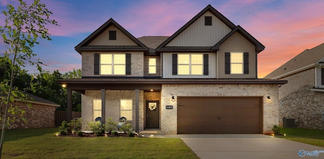 16821 Demi Dr, Athens, AL 35613 - view of front of property with a front lawn, board and batten siding, concrete driveway, a garage, and brick siding