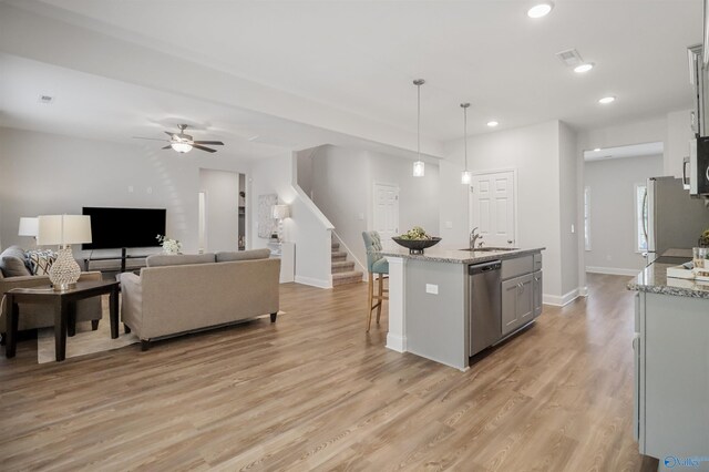 16821 Demi Dr, Athens, AL 35613 - kitchen featuring a sink, stainless steel appliances, light wood-style flooring, a kitchen breakfast bar, and a ceiling fan