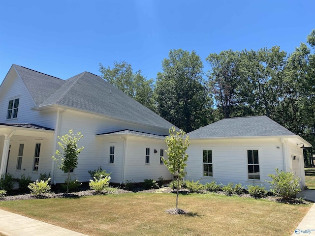 view of side of property with a lawn