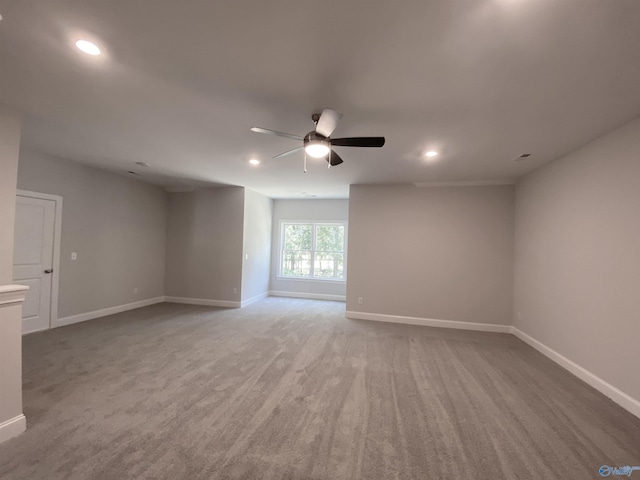 spare room with ceiling fan and carpet