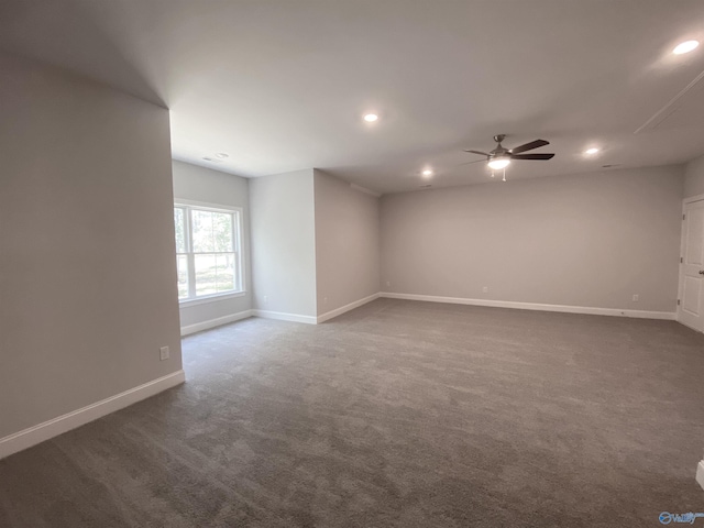 unfurnished room featuring dark carpet and ceiling fan