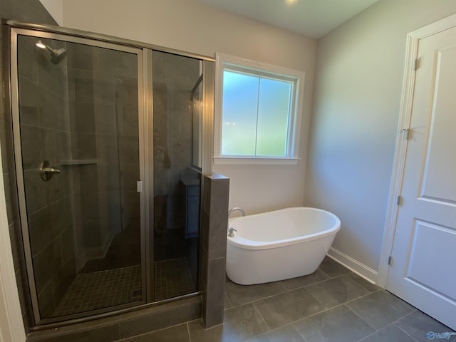 bathroom featuring plus walk in shower and tile patterned flooring