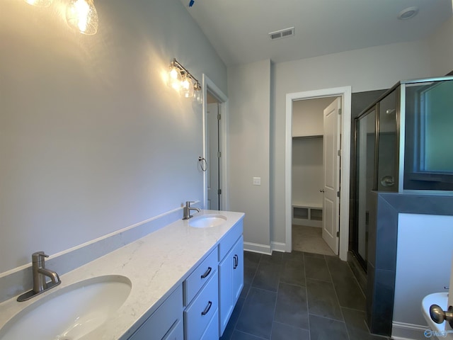 bathroom featuring vanity, an enclosed shower, and tile patterned floors