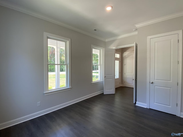 unfurnished bedroom with multiple windows, crown molding, and dark hardwood / wood-style floors