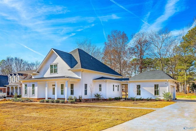 view of front of property with covered porch and a front yard