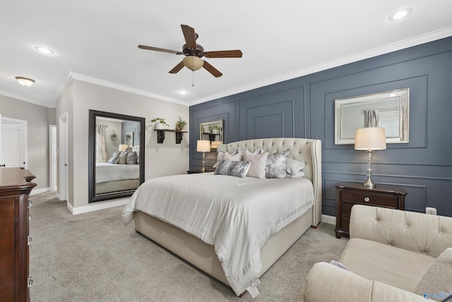 bedroom featuring crown molding, baseboards, ceiling fan, light carpet, and a decorative wall