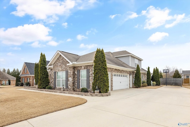 view of front of property with fence, roof with shingles, concrete driveway, a garage, and brick siding