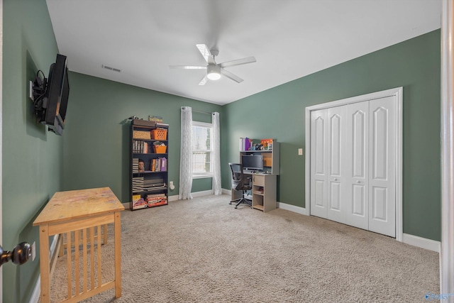 carpeted office with visible vents, baseboards, and ceiling fan