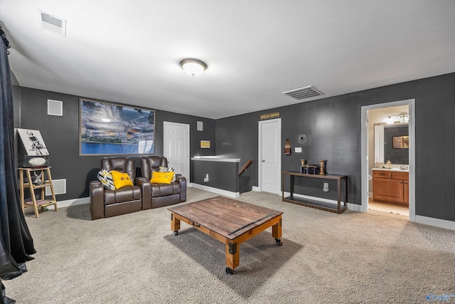 living area with baseboards, visible vents, and light carpet