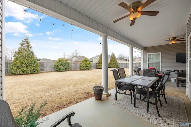 view of patio featuring outdoor dining area, a ceiling fan, and a fenced backyard