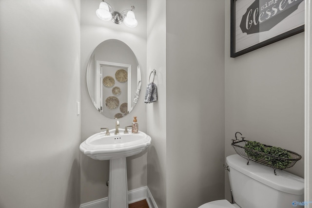 bathroom featuring toilet and baseboards