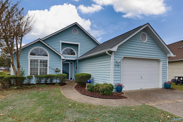 view of front of house featuring a front yard and a garage