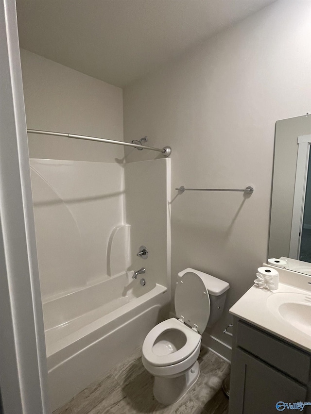 full bathroom featuring washtub / shower combination, vanity, hardwood / wood-style flooring, and toilet