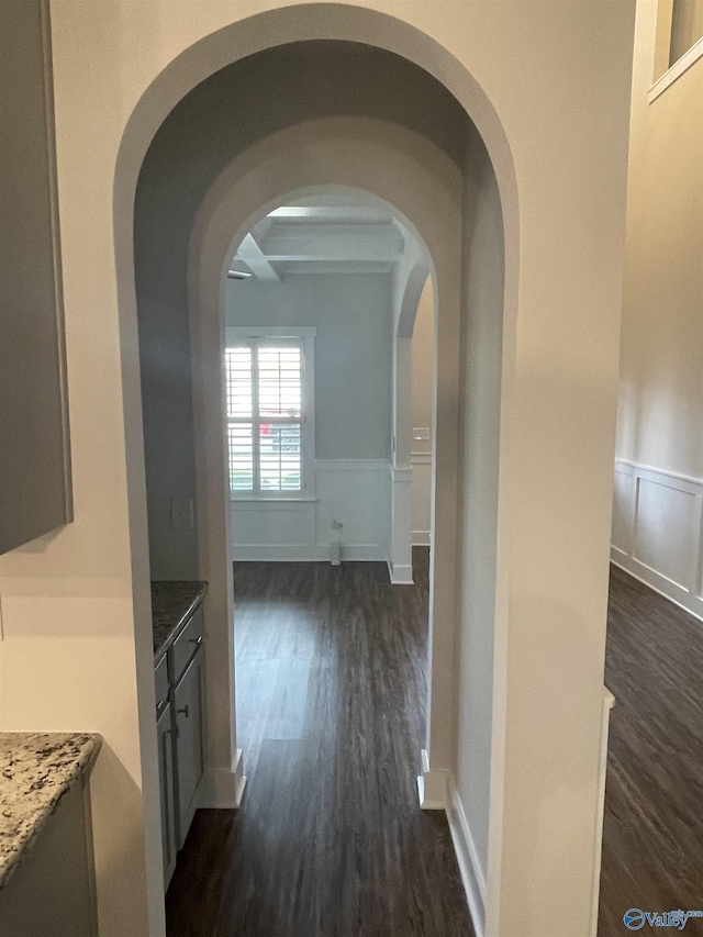 hallway with beamed ceiling and dark wood-type flooring