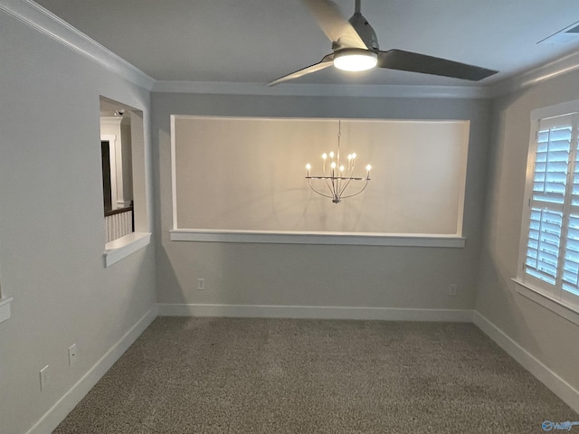 carpeted spare room featuring crown molding and ceiling fan with notable chandelier