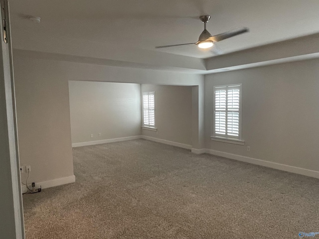 spare room featuring carpet and ceiling fan