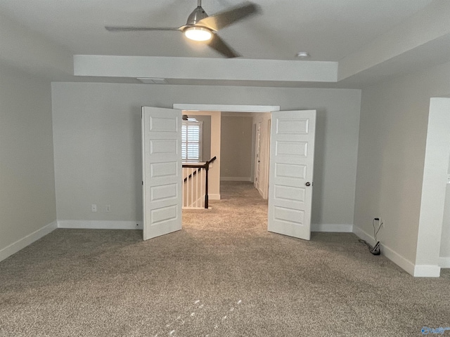 unfurnished room with carpet flooring, ceiling fan, and a tray ceiling