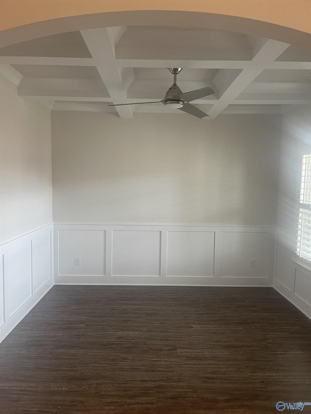 empty room with beamed ceiling, dark wood-type flooring, ceiling fan, and coffered ceiling