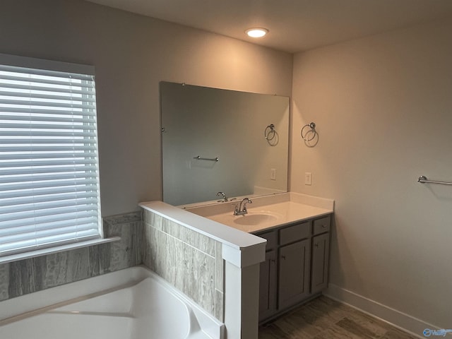 bathroom with vanity and a bath